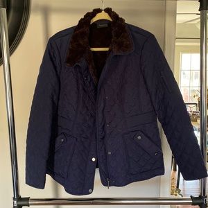 Quilted Weatherproof jacket with fur. Zipper and buttons for closure. Pockets.